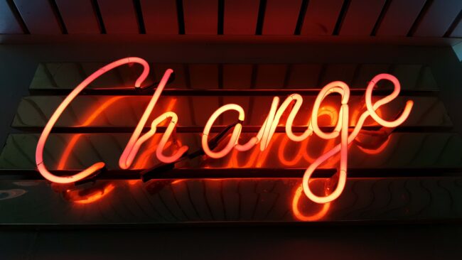 orange italic neon letters, says "change"